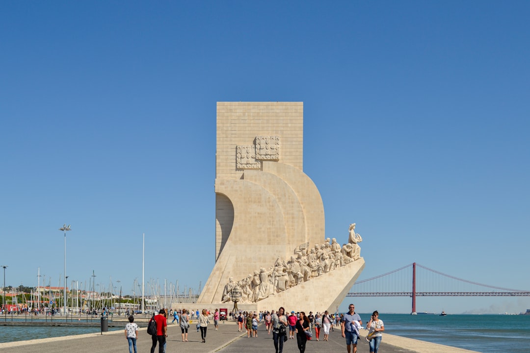A small group walking the riverside monuments of Belém