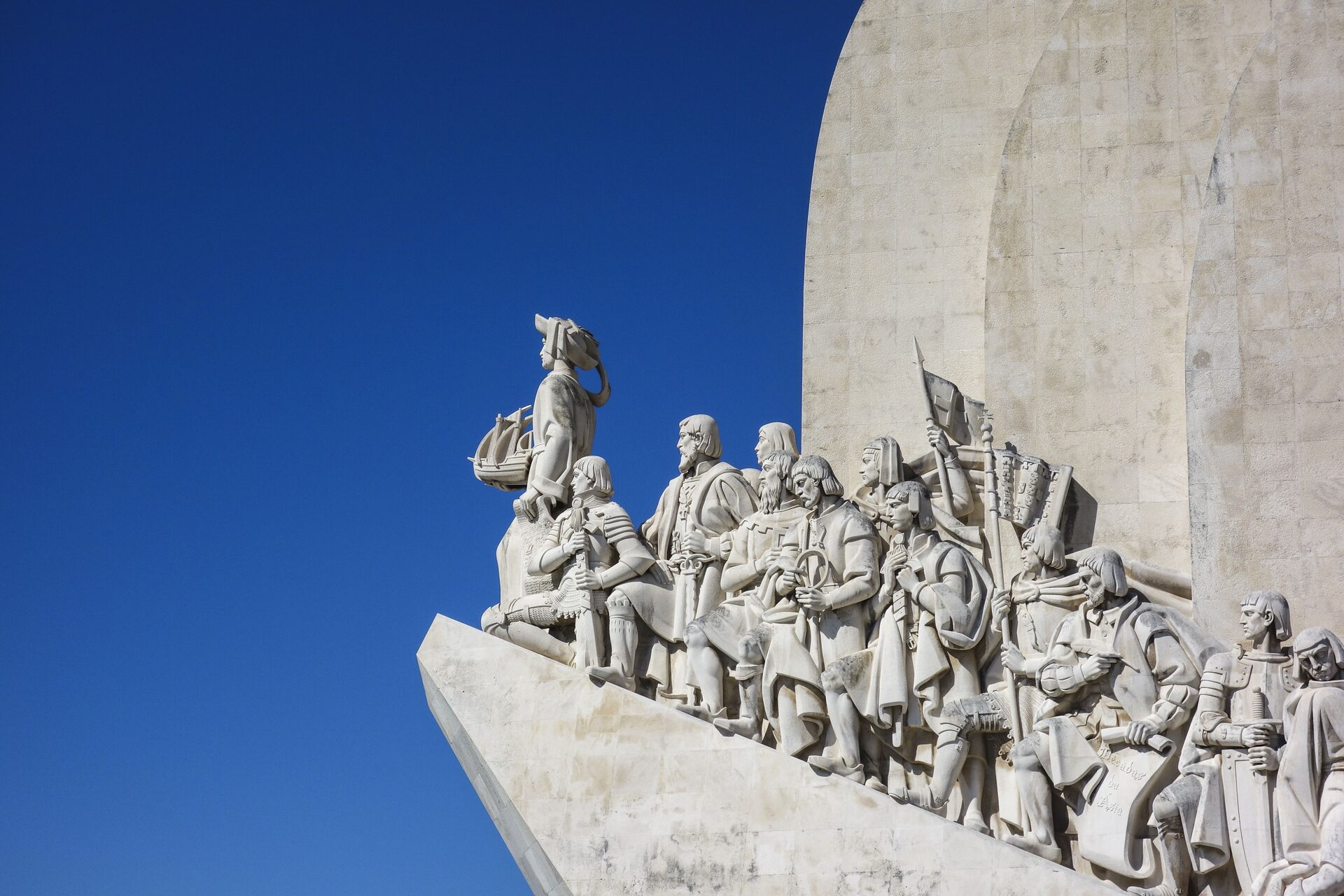 The stone navigators of the Padrao dos Descobrimentos in Belem against a clear blue sky