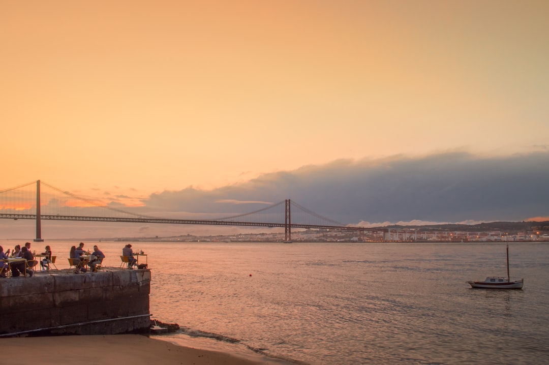 A boat sailing on the Tagus at golden hour