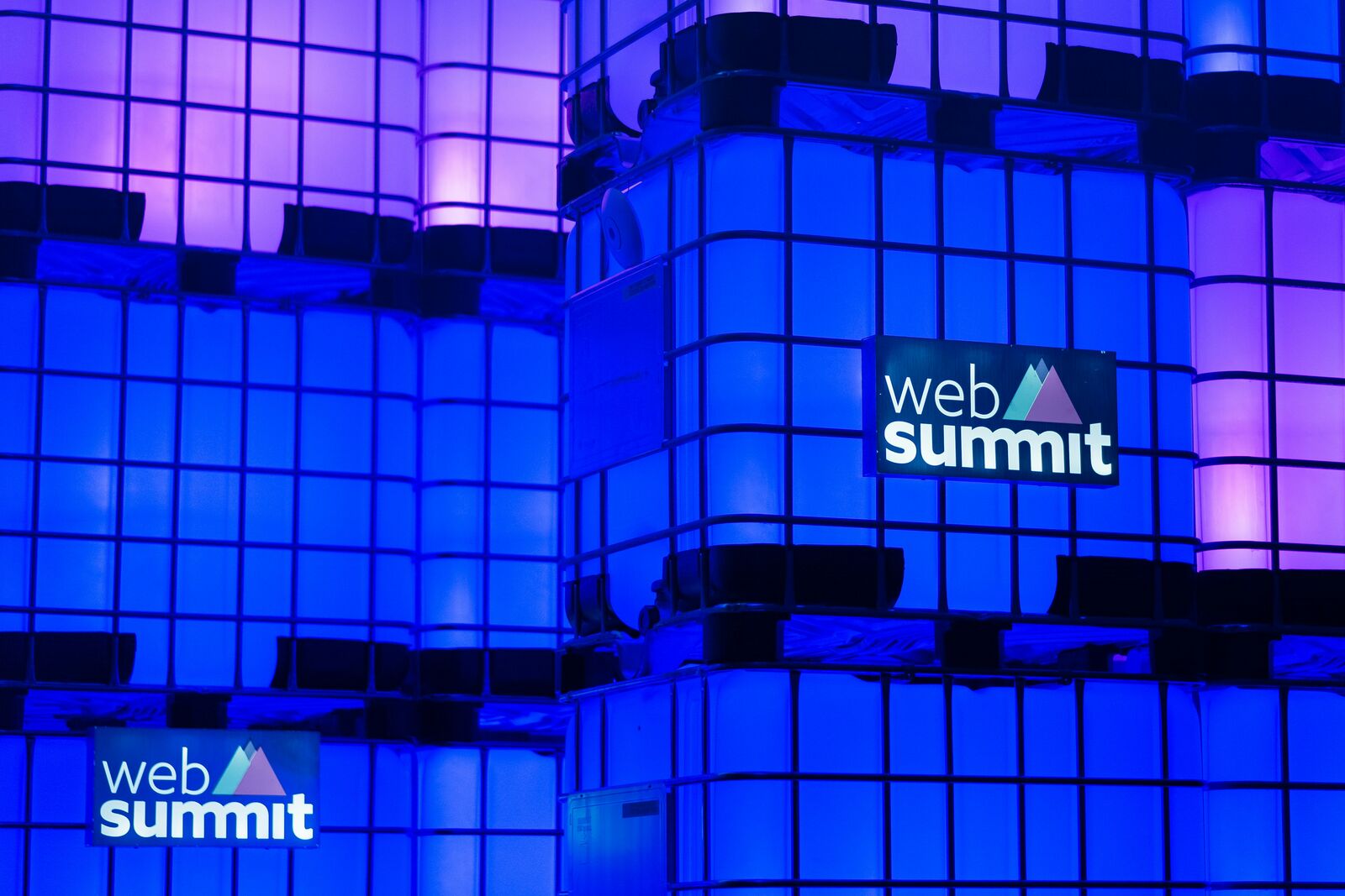 The Web Summit logo lit up in blue on branded panels at the venue